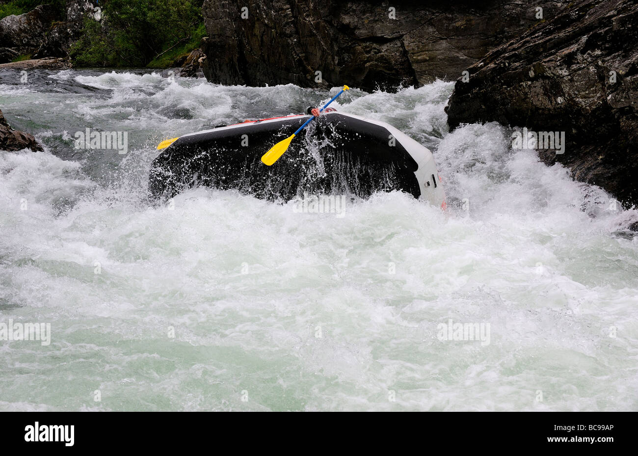 Rafting overturn in white water river Stock Photo