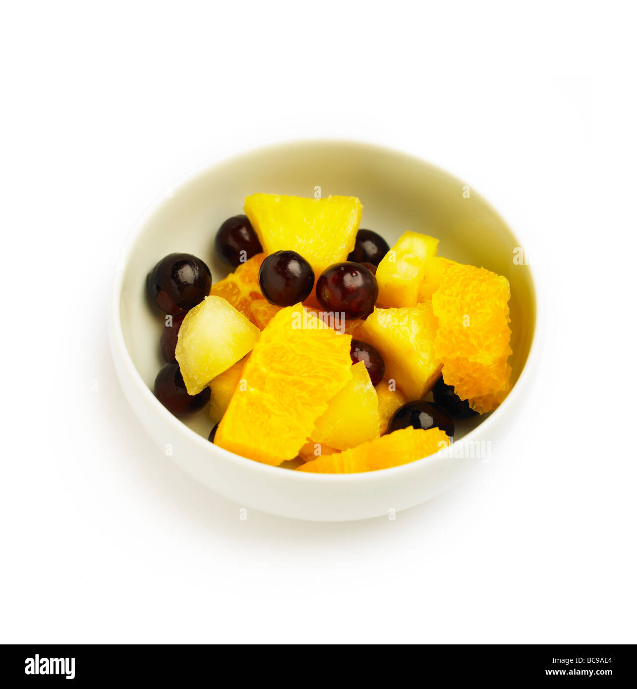 White bowl with fresh fruit salad on a white background Stock Photo - Alamy