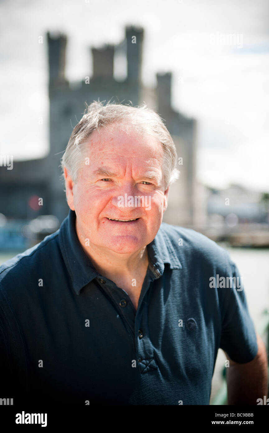 Dafydd Iwan welsh singer politician and businessman, photographed in Caernarfon, with the castle in the background Stock Photo