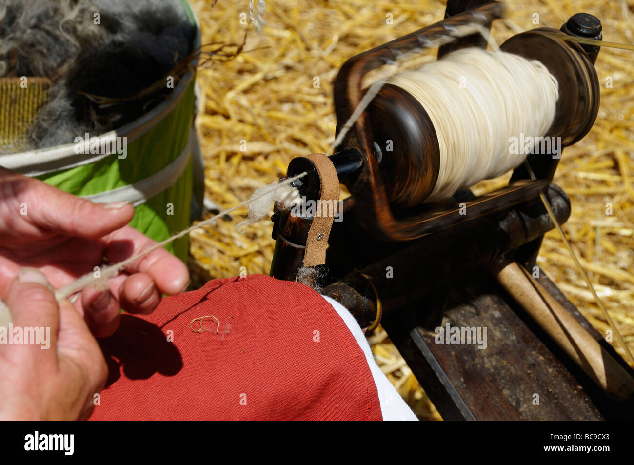 Stock photo of a woman spinning wool on her spinning wheel Stock Photo ...