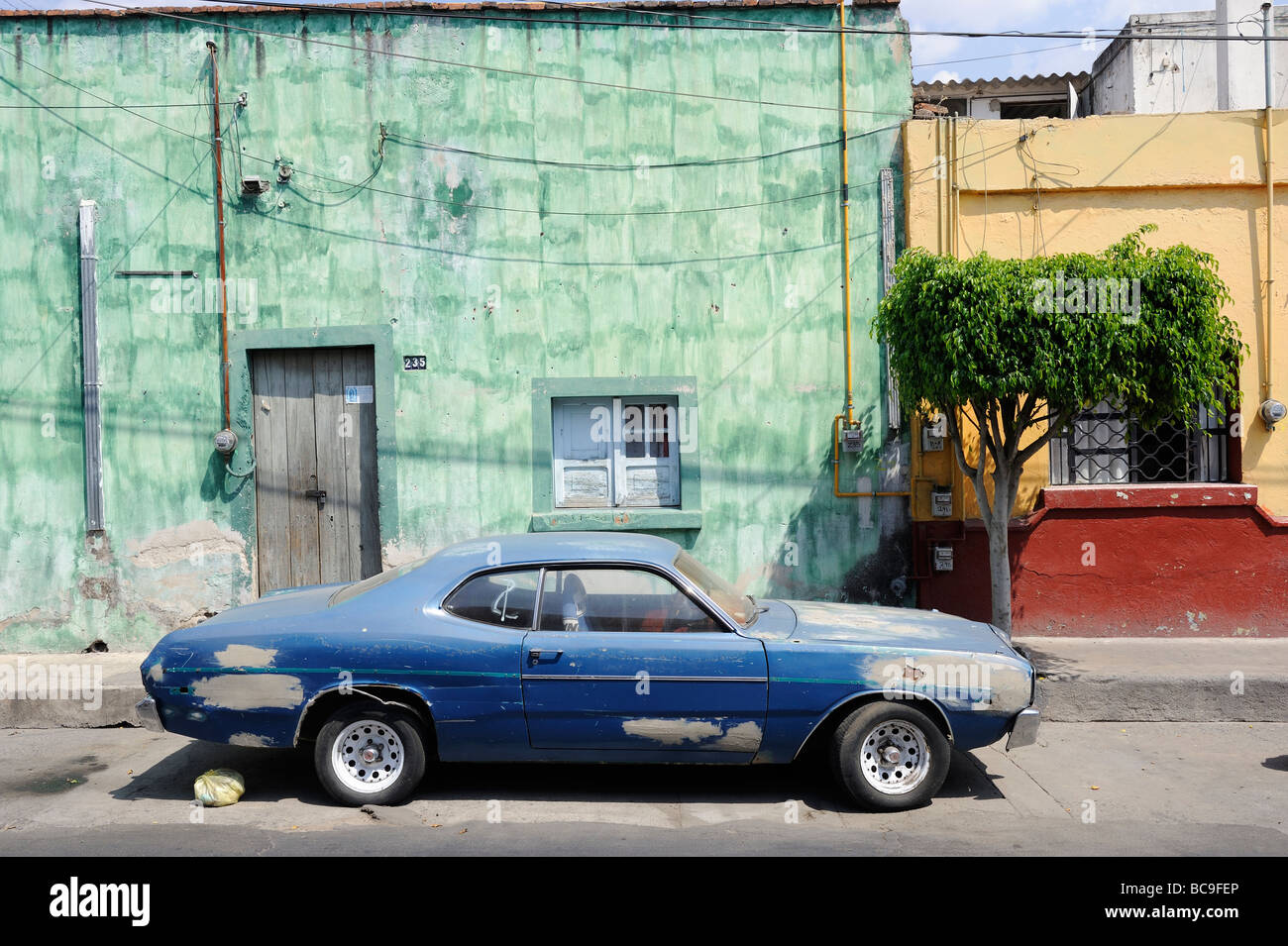 Old car by green wall in Tlaquepaque, Jalisco, Mexico Stock Photo Alamy