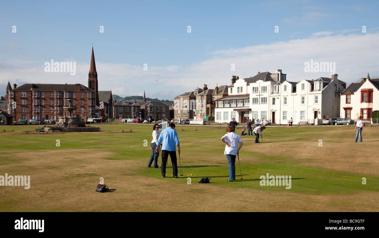 People enjoying putting on the putting green at Largs, a seaside resort