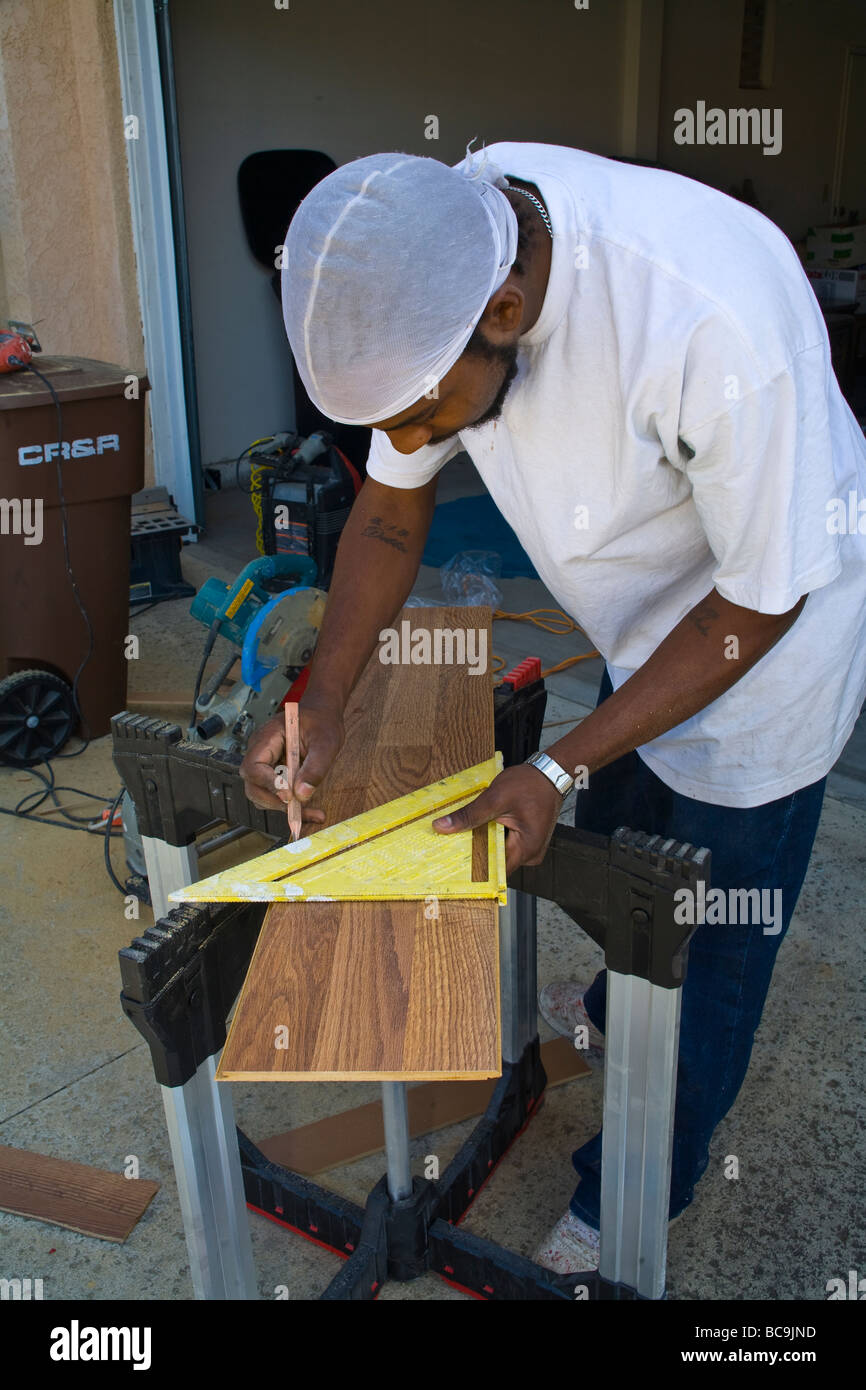 Man measures wood laminate for home flooring MR  © Myrleen Pearson Stock Photo