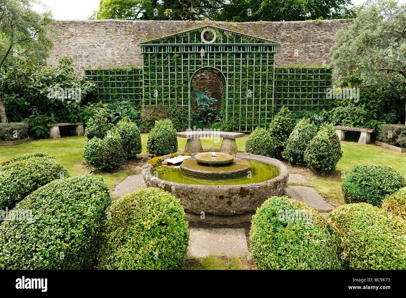 Trellis with boxed hedges and water feature in an English Garden in Somerset, UK Stock Photo