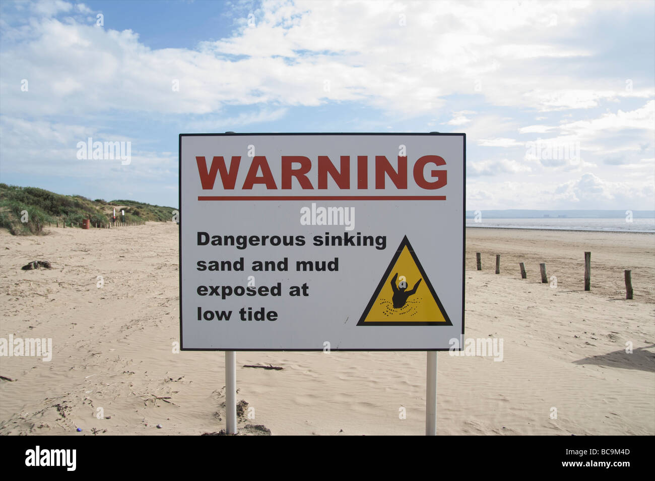 Warning sign of dangerous mud and sinking sand Stock Photo Alamy