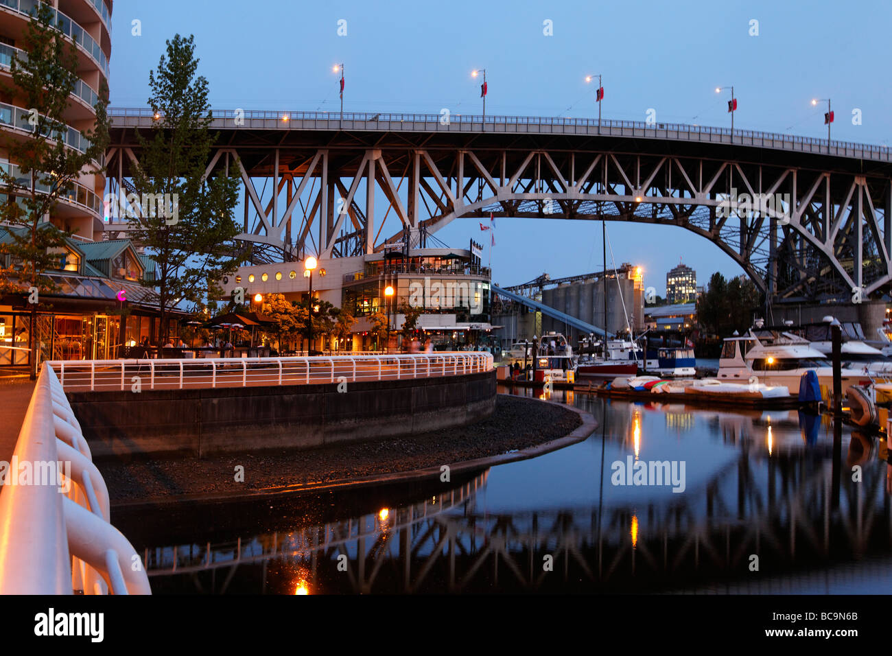 Promande and small Marina at False Creek at twilight Granville Bridge Vancouver Canada North America Stock Photo