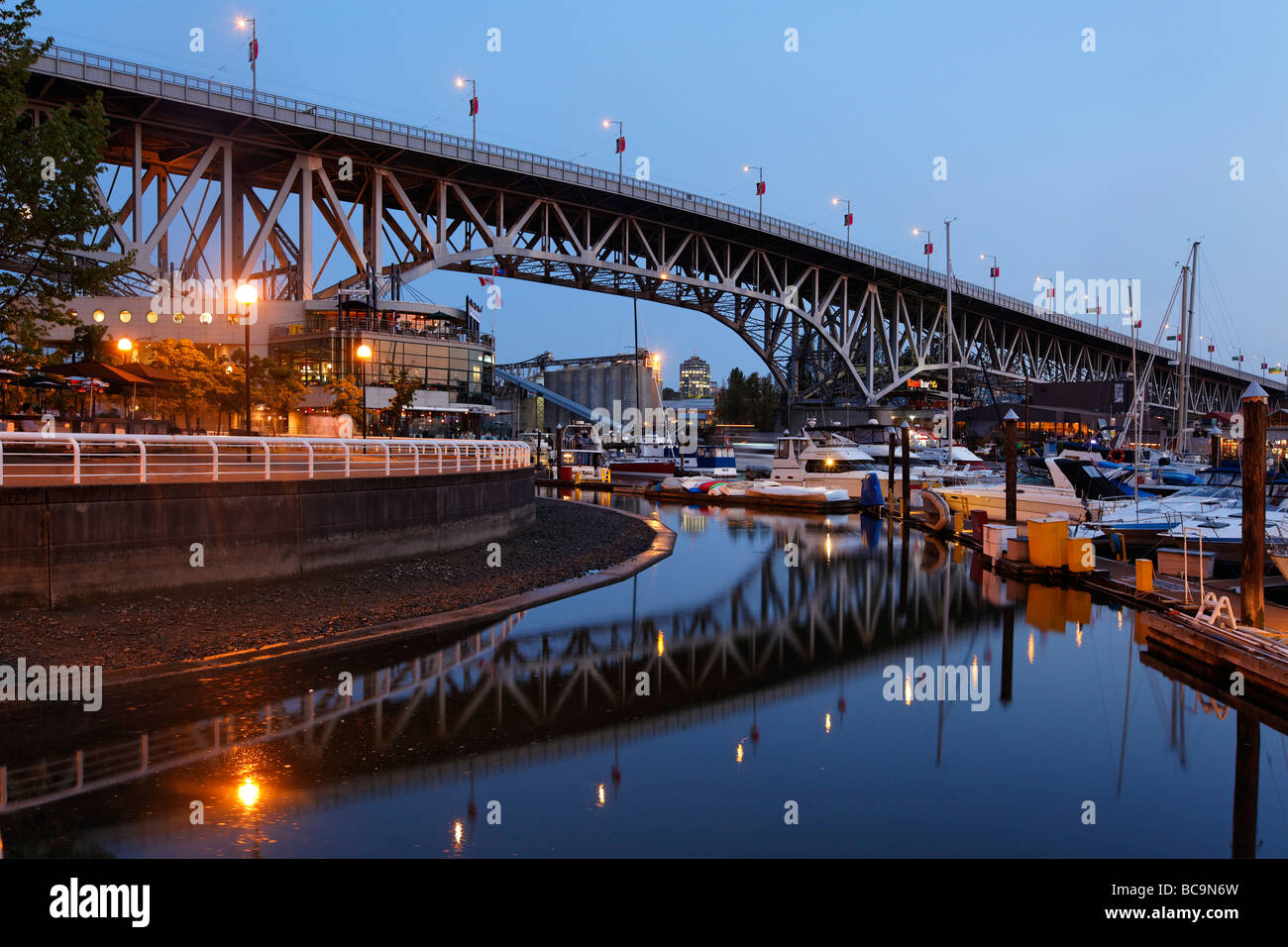 Promande and small Marina at False Creek at twilight Granville Bridge Vancouver Canada North America Stock Photo