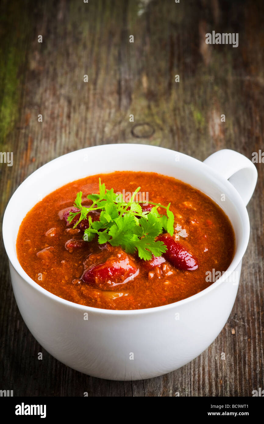 A cup of chili con carne with coriander Stock Photo