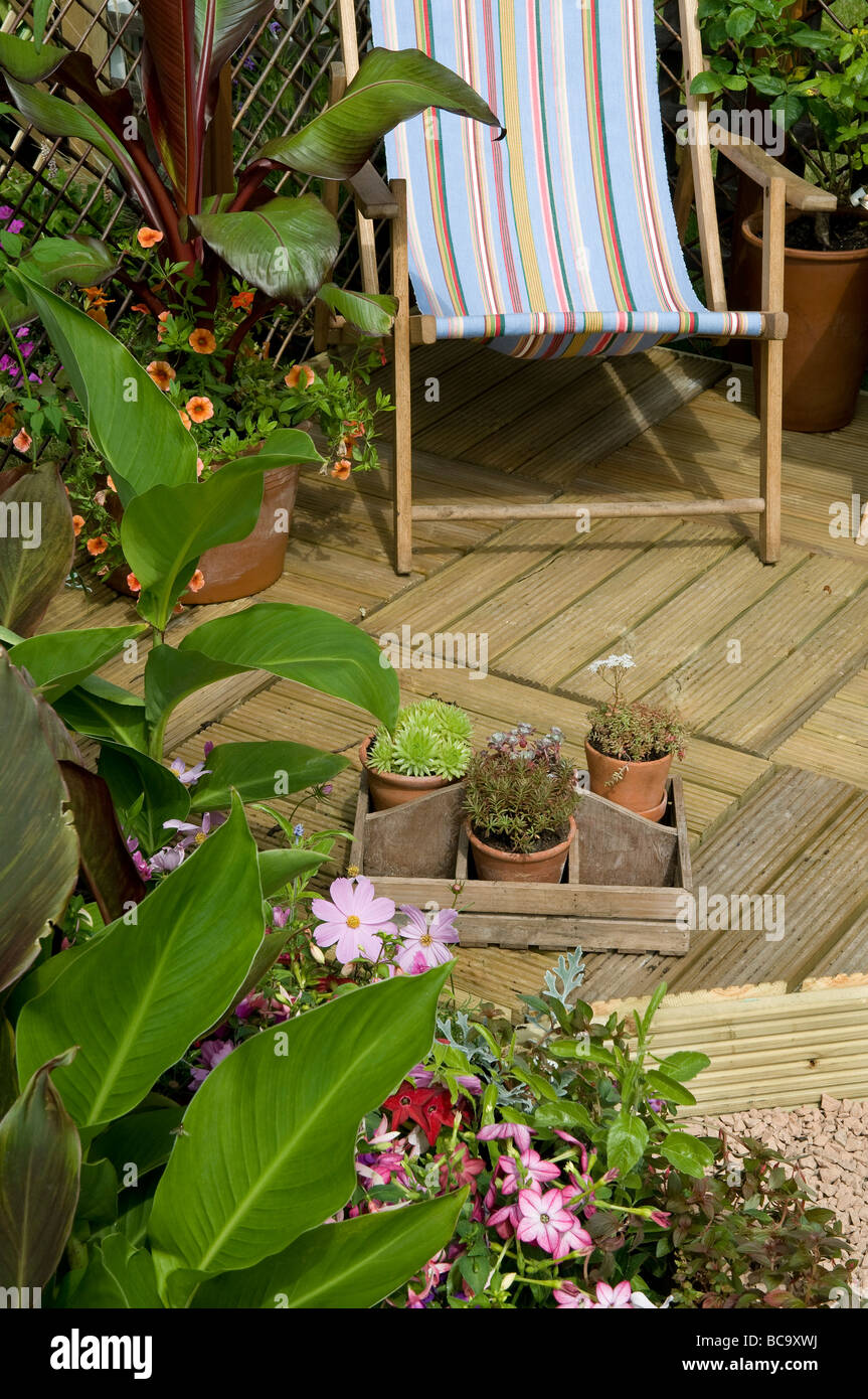 deck chair on timber decking in garden Stock Photo