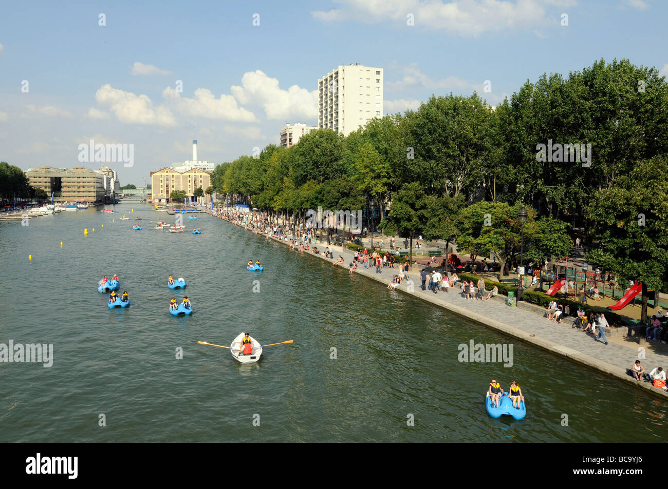 Parisians enjoying a hot summer day near the Bassin de la Villette in northern Paris, France Stock Photo