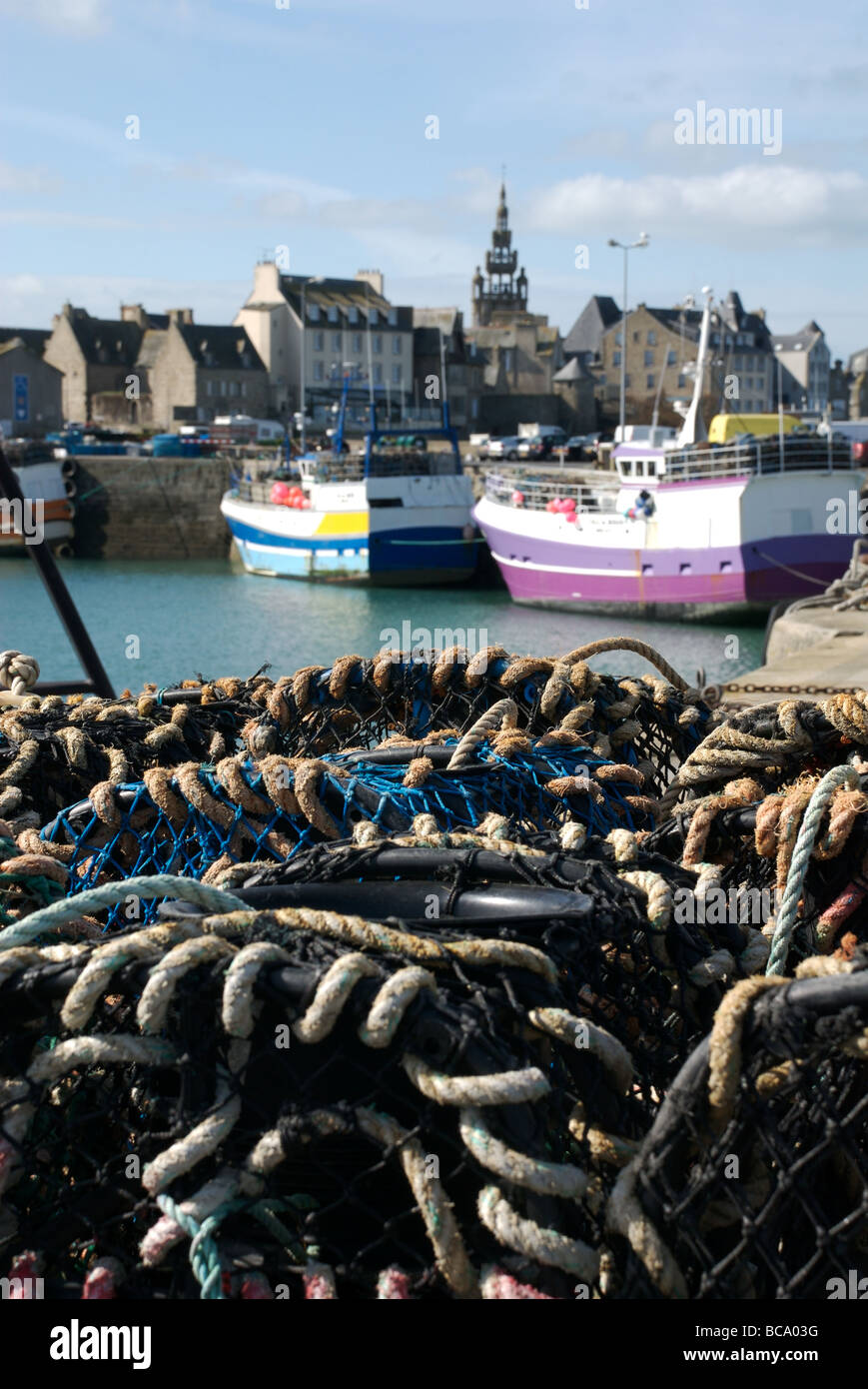Fishing pots and colourful boats, Roscoff, Brittany, France Stock Photo