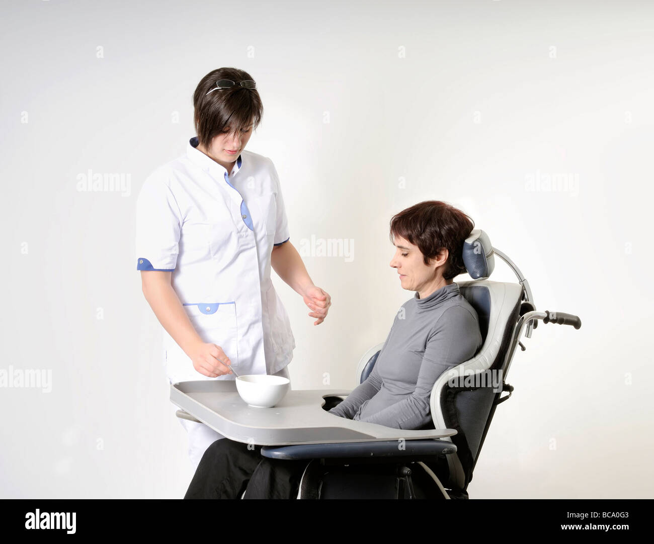 nurse feeding a disabled woman Stock Photo Alamy