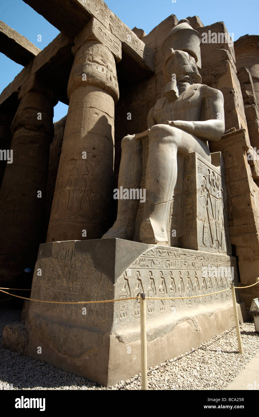 A gigantic statue of Ramses II at Luxor Temple guarding the entrance to ...