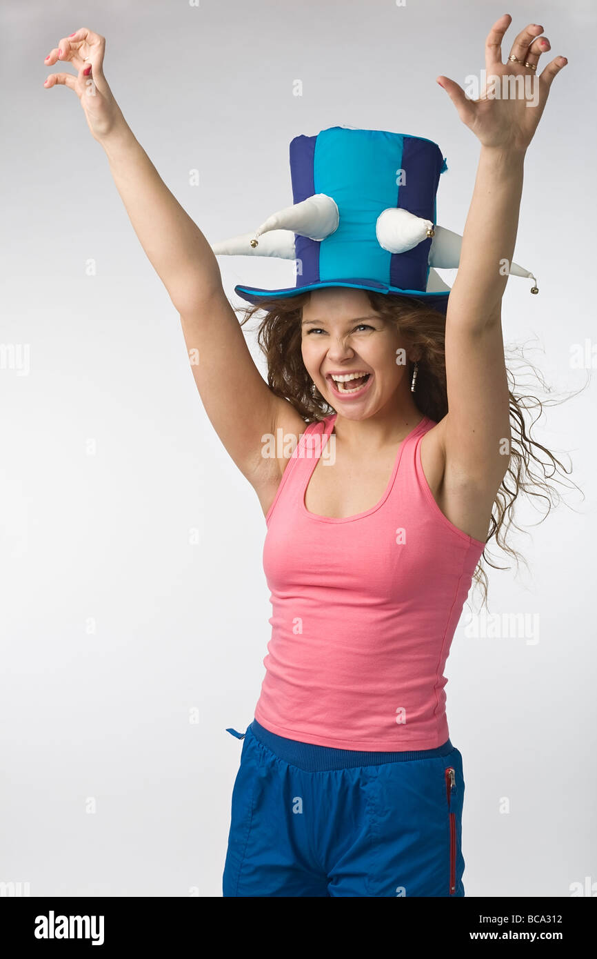 emotionall girl in big football fan hat on gray background Stock Photo