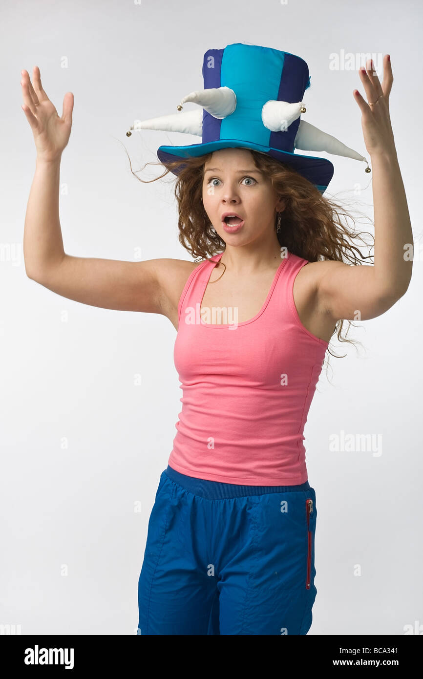 emotionall girl in big football fan hat on gray background Stock Photo