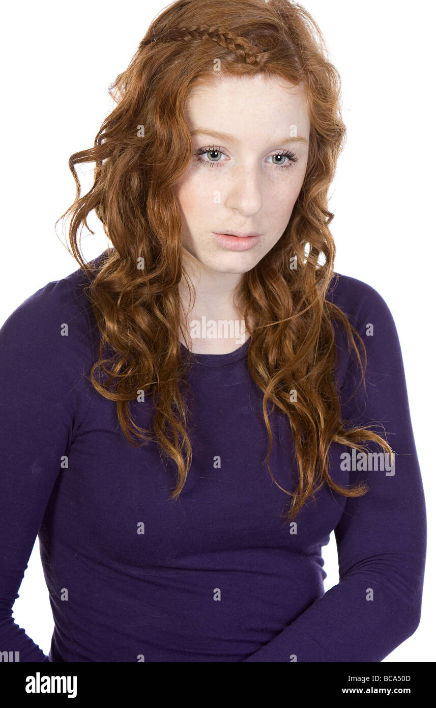 Shot of a Red Headed Teen Looking Sad against White Background Stock Photo