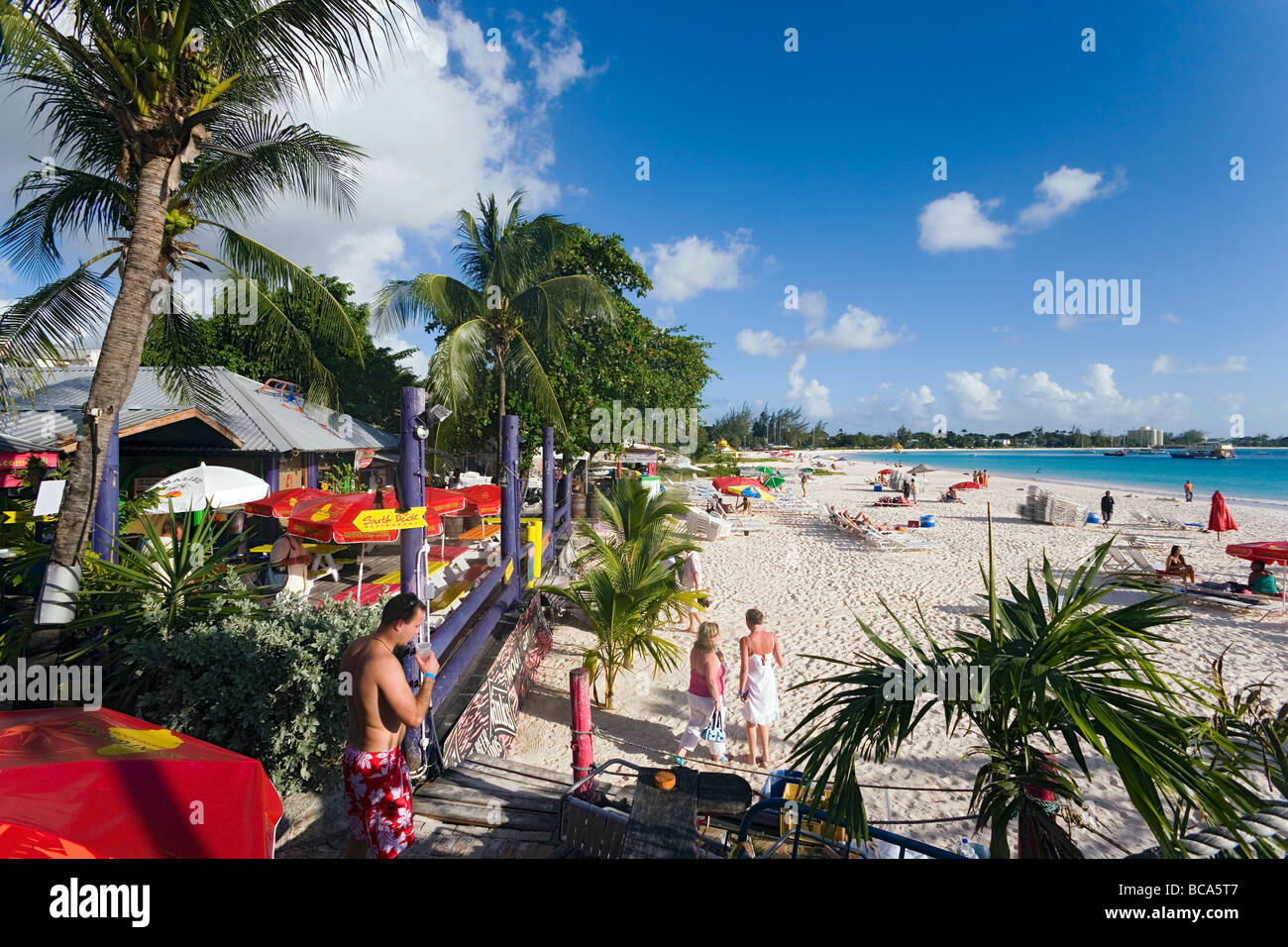 People relaxing at beach near the Boatyard beach bar, Bridgetown, Barbados, Caribbean Stock Photo