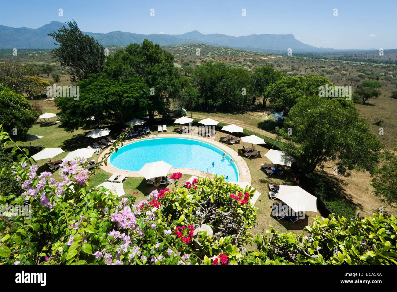 View over swimming pool of Taita Hills Lodge, Taita hills in background, Coast, Kenya Stock Photo
