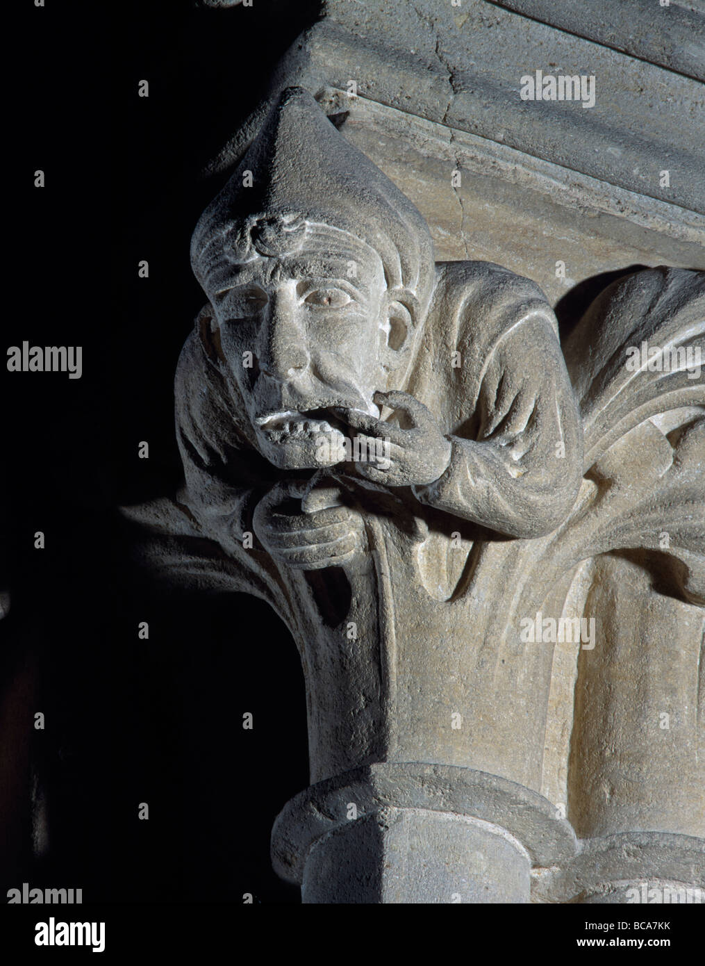 Wells Cathedral Somerset. Capital in south transept of man with toothache. Stock Photo