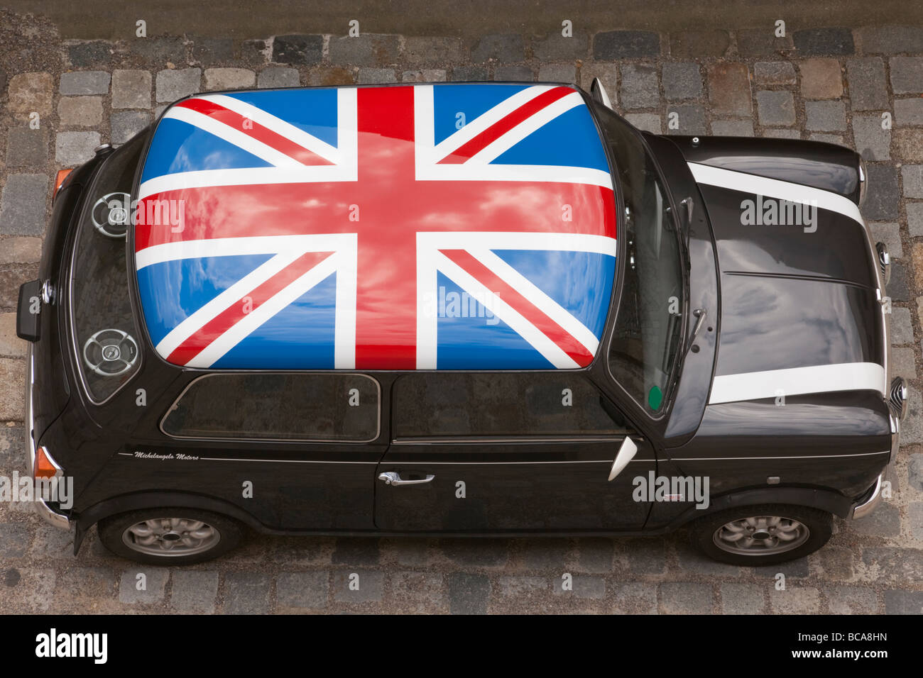 Europe Union Jack painted on roof of a black Mini car from above Stock Photo