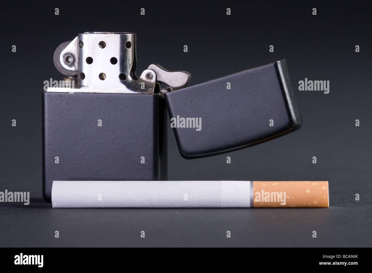 lighter and cigarette on dark background Stock Photo
