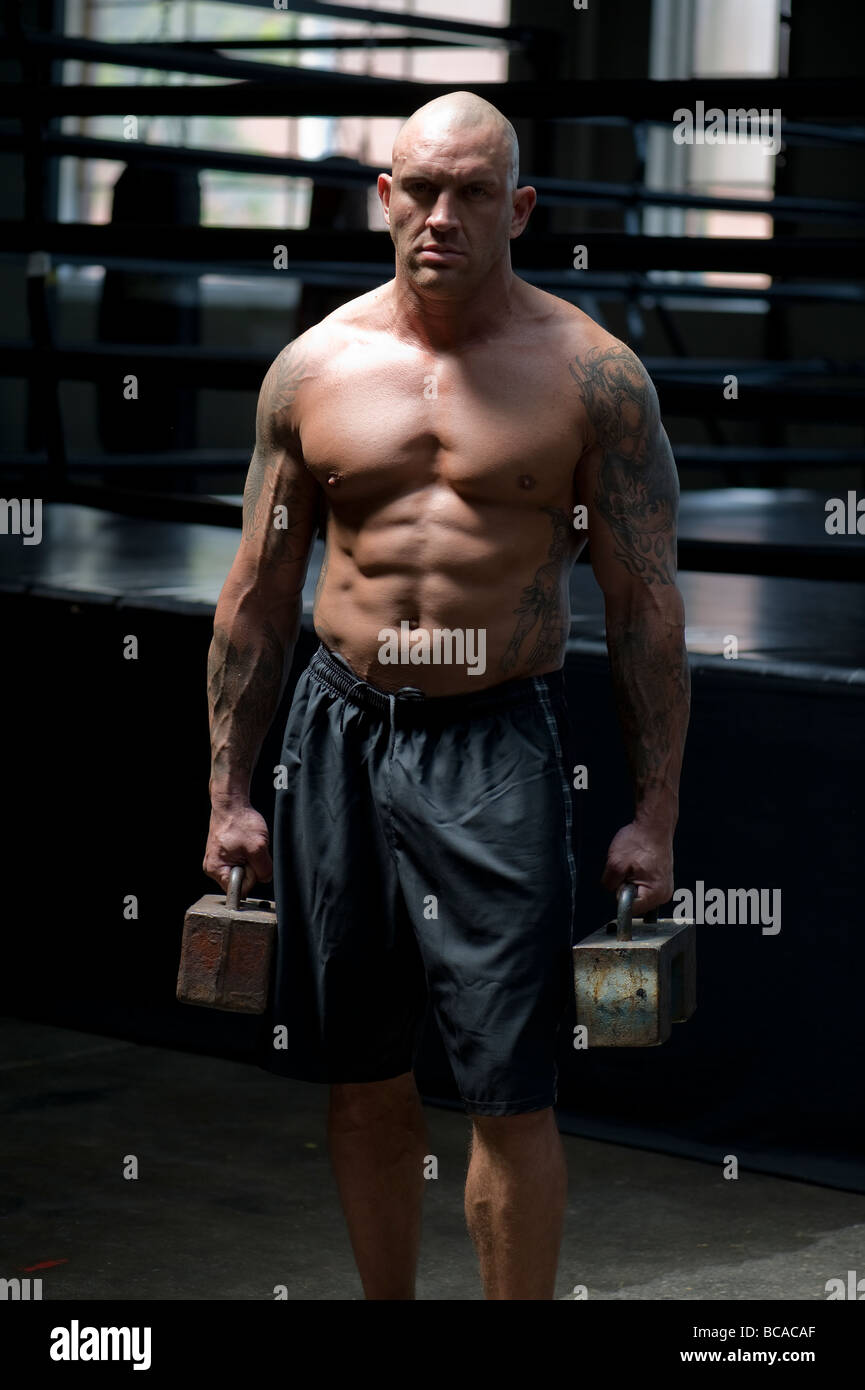 A mixed martial arts fighter demonstrates his strength Stock Photo - Alamy