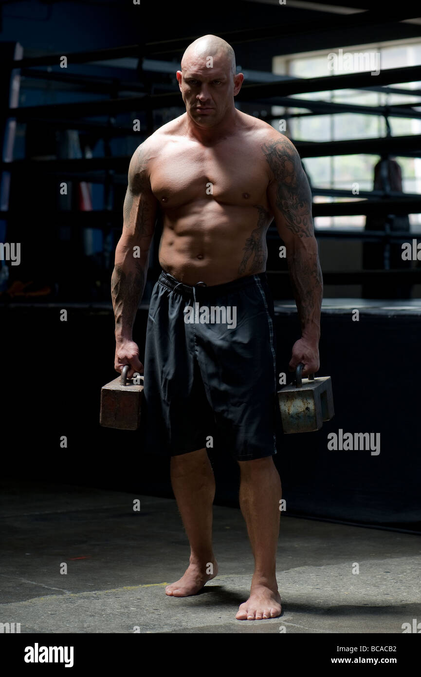 A mixed martial arts fighter demonstrates his strength Stock Photo - Alamy