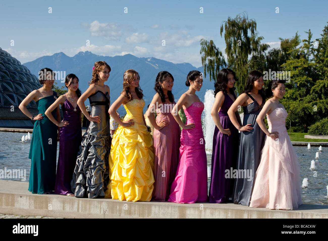 students in formal dress for school prom posing for photographs at Queen Elizabeth Park, Vancouver, British Columbia, Canada Stock Photo