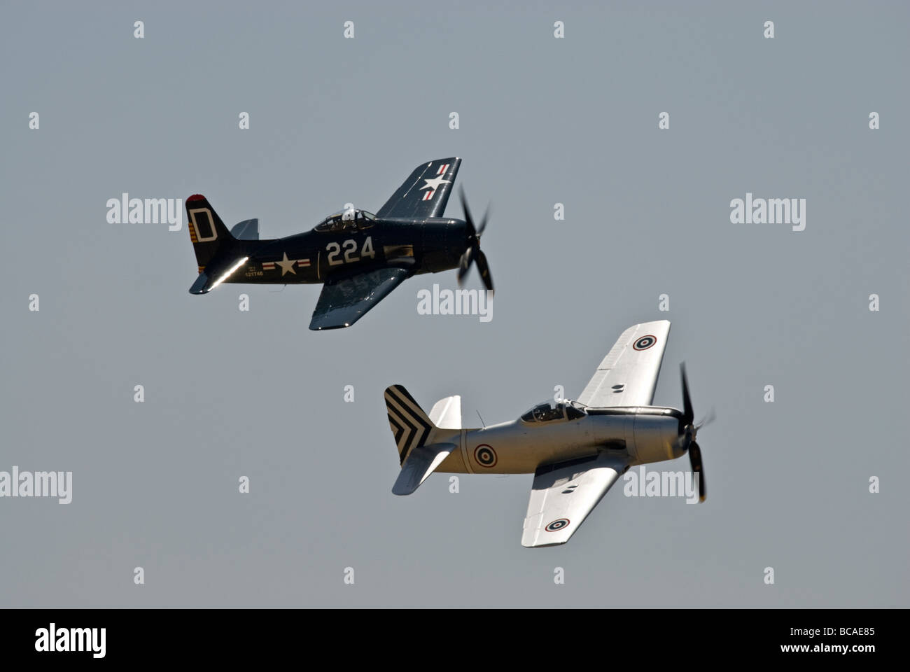 Two Grumman F8F Bearcats fly in formation at an air show. Stock Photo