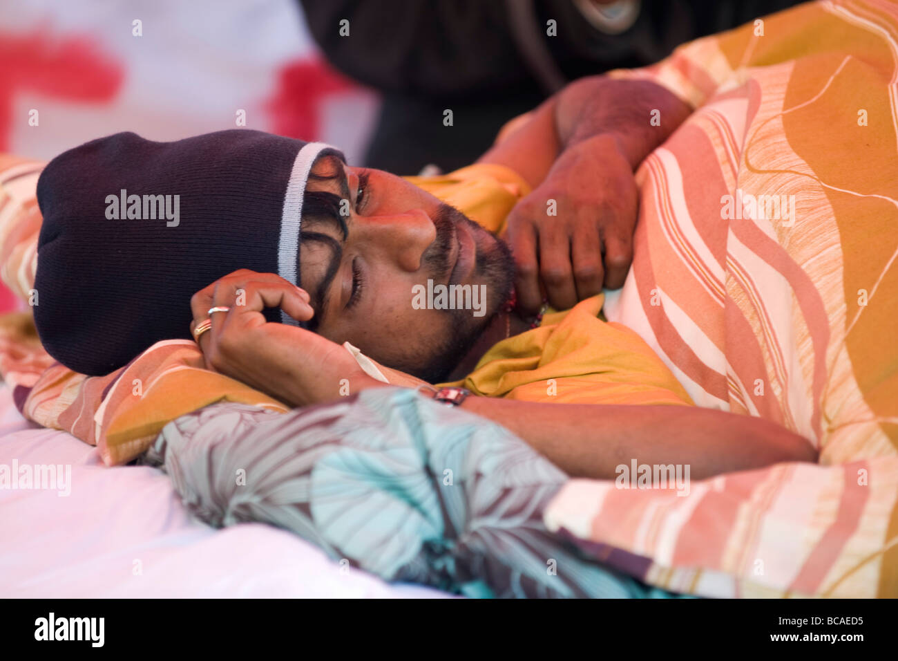 Tamil protester Prarameswaran Subramaniam huddled under blankets in the