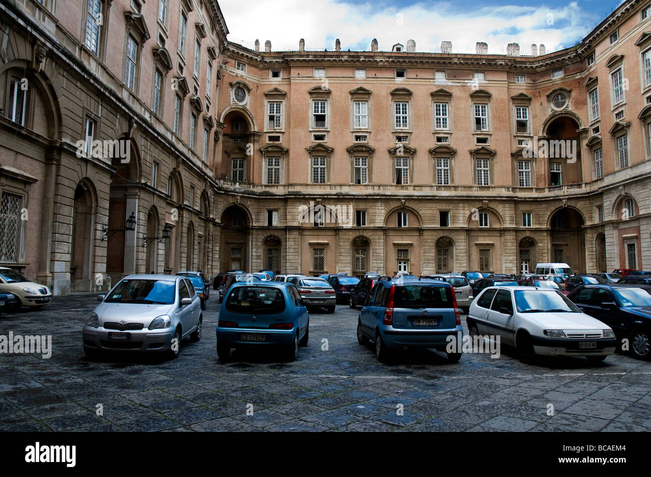 A courtyard used as a car park in The Royal Palace of Caserta, a former