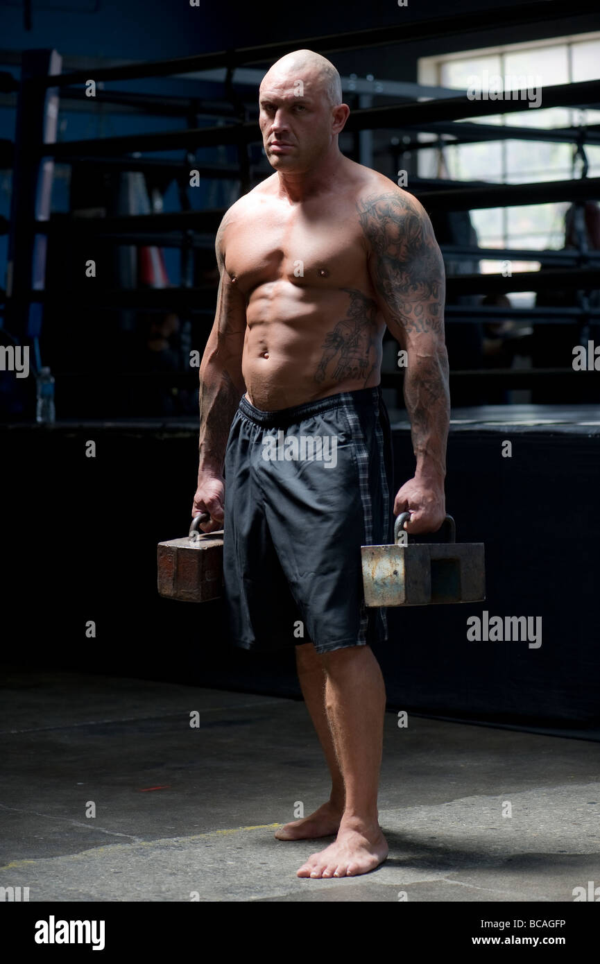 A mixed martial arts fighter demonstrates his strength Stock Photo Alamy