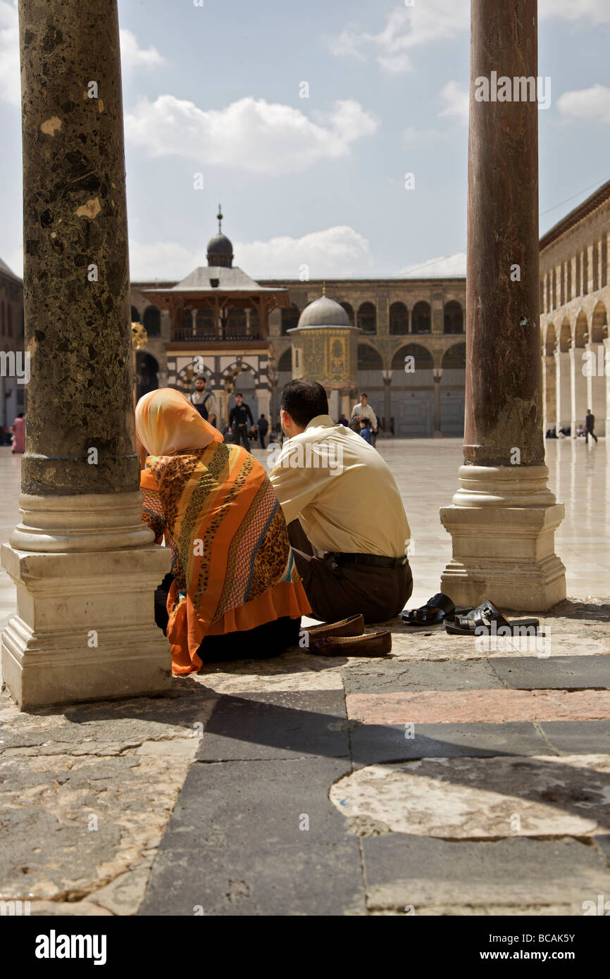Man & woman sitting under Dome of The Clocks in courtyard, Great Umayyad Mosque, Old City, Damascus, Syria Stock Photo