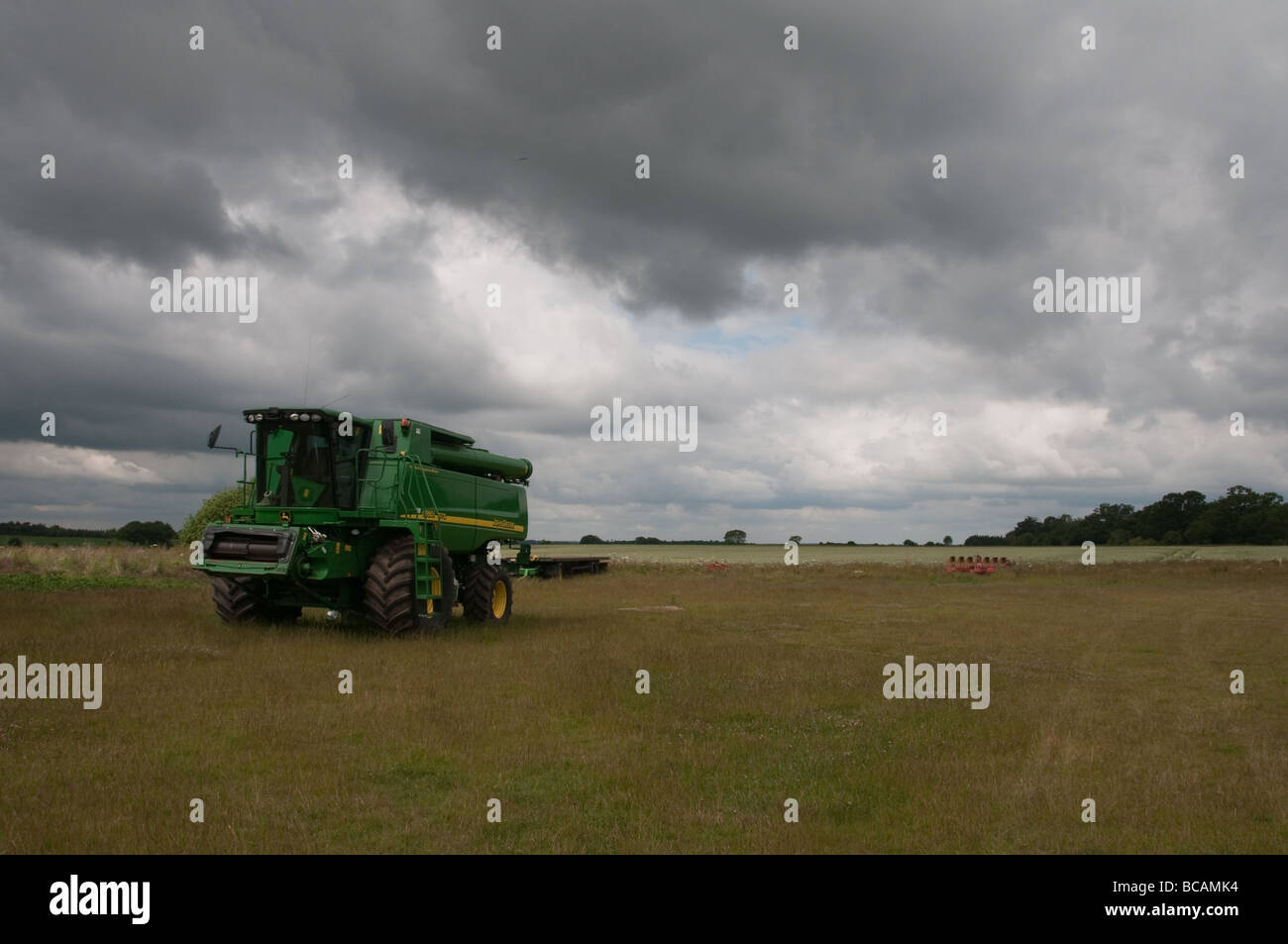 Suffolk Field with John Deere and storm coming Stock Photo Alamy
