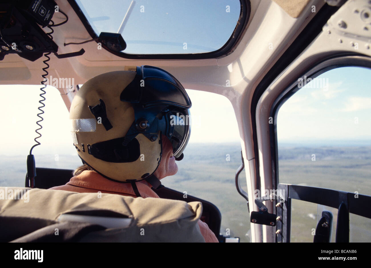 A Helicopter Pilot flying over remote coastal button grass plains. Stock Photo