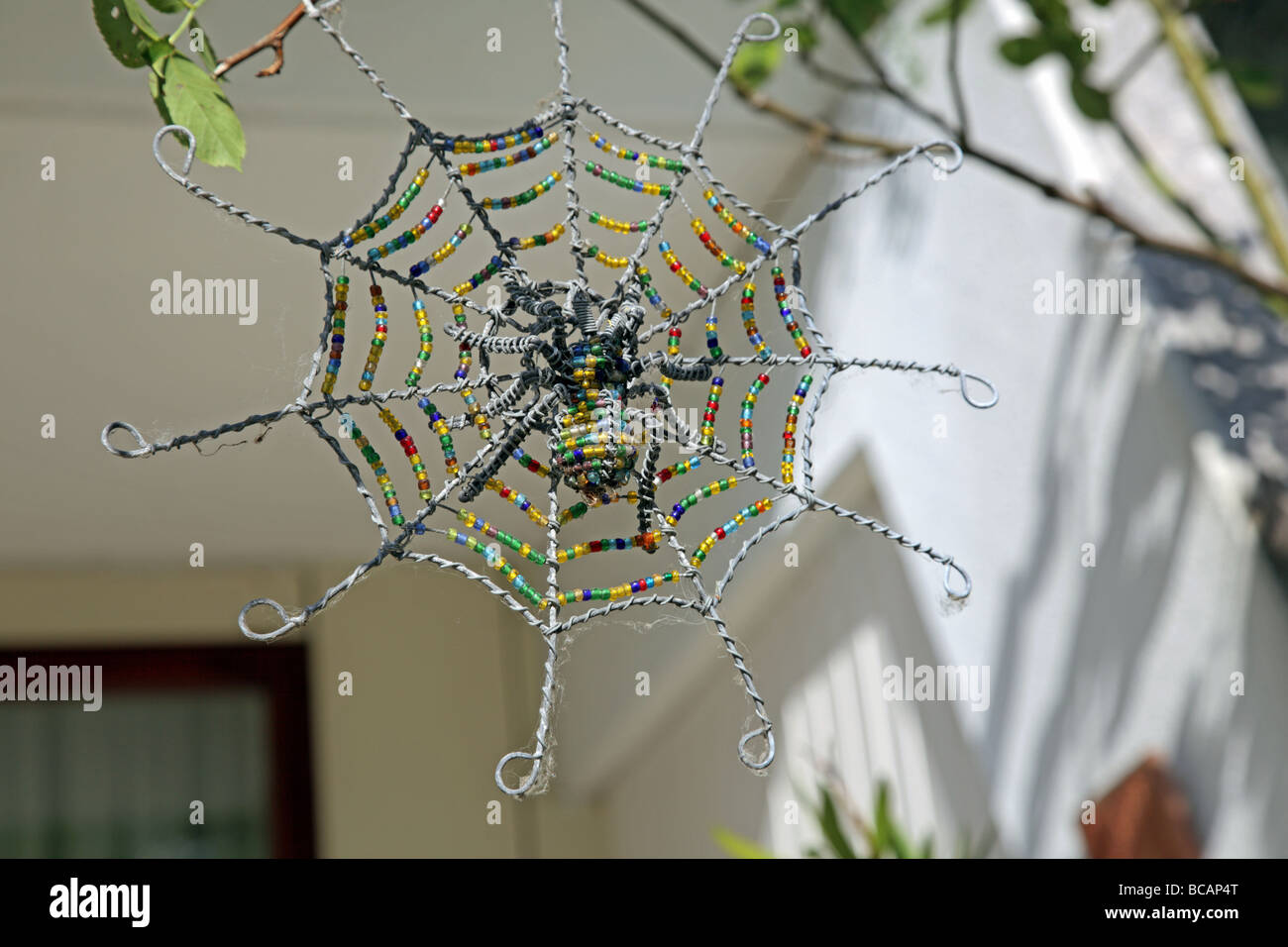 articial spider and net made of beads Zulu art South Africa Stock Photo