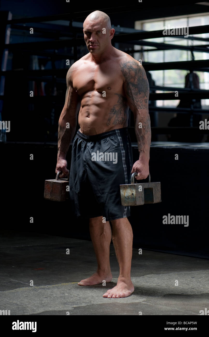 A mixed martial arts fighter demonstrates his strength Stock Photo - Alamy