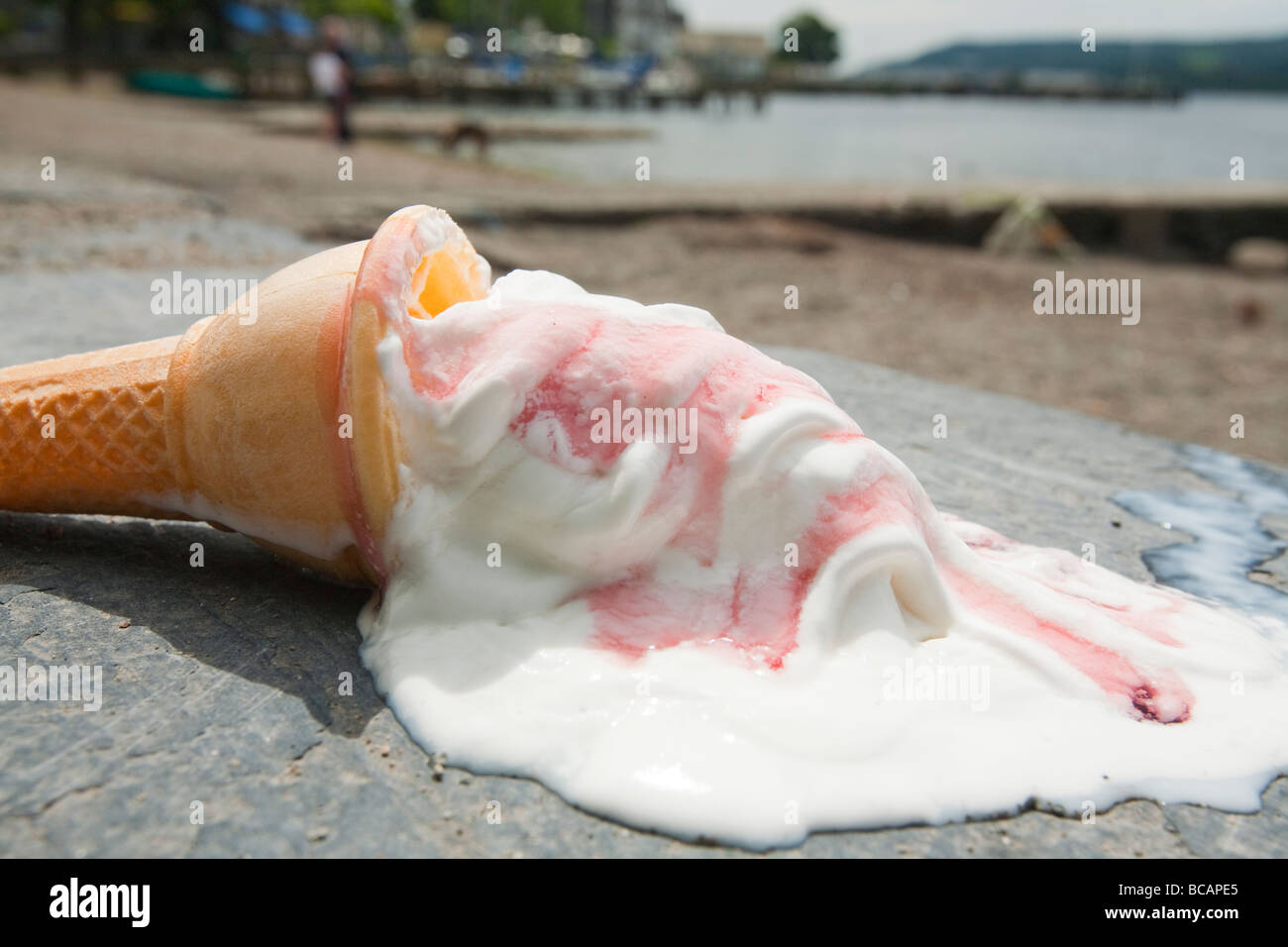 An ice cream melting on the shores of Lake Windermere Cumbria UK during a summer heat wave Stock Photo