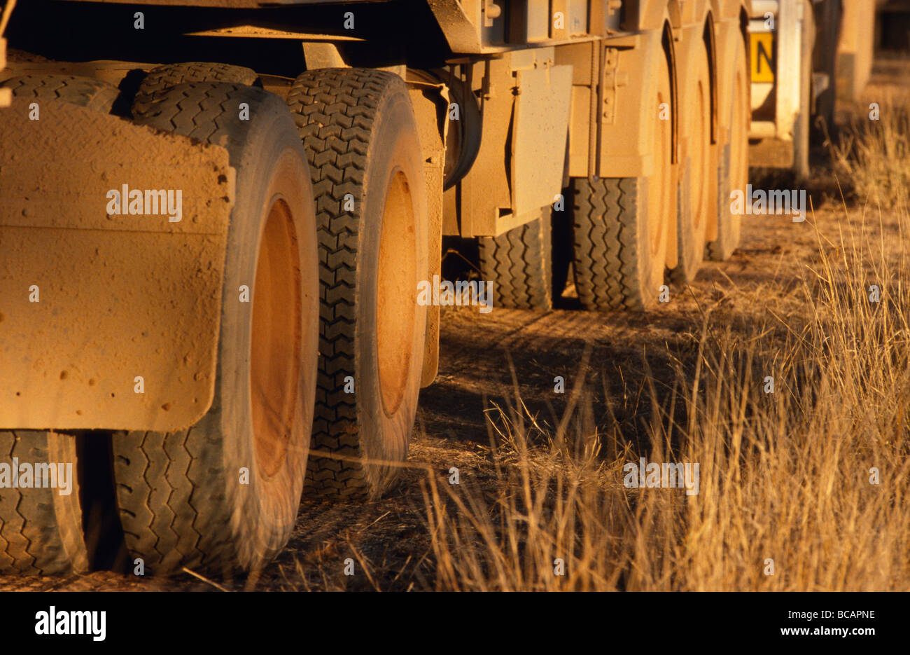 The dusty wheels of a Long-Haul Truck, also called a Road Train. Stock Photo