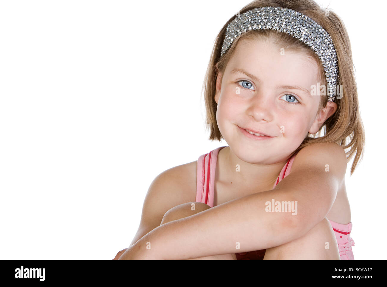 Studio Shot Of A Cute Blonde Haired Child With Sparkly Hairband
