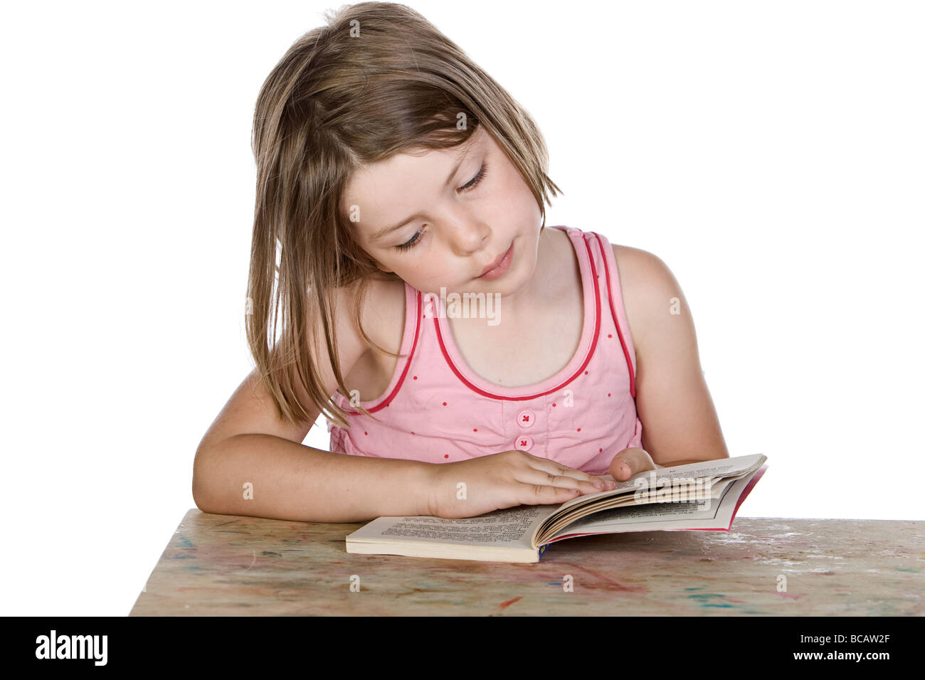 Shot of a Cute Blonde Child Reading her Book Stock Photo