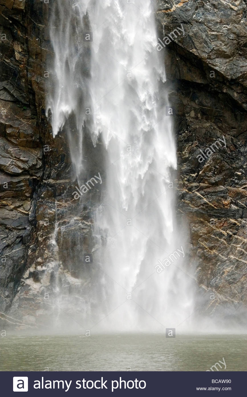 Waterfall tumbles against fractured metamorphic rock. Stock Photo