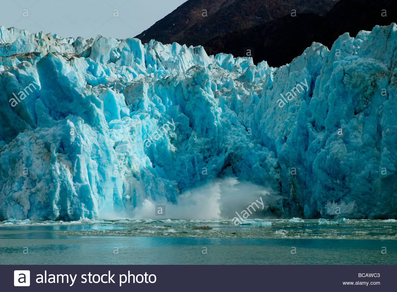 Blue ice calving along glacier front of South Sawyer Glacier. Stock Photo