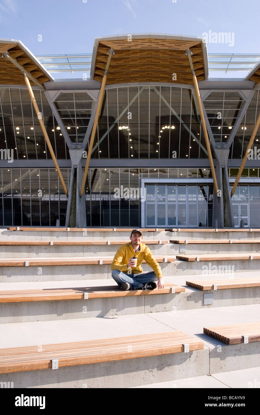 Building exterior of man outside Richmond Olympic Oval, Richmond, British Columbia, Canada Stock Photo