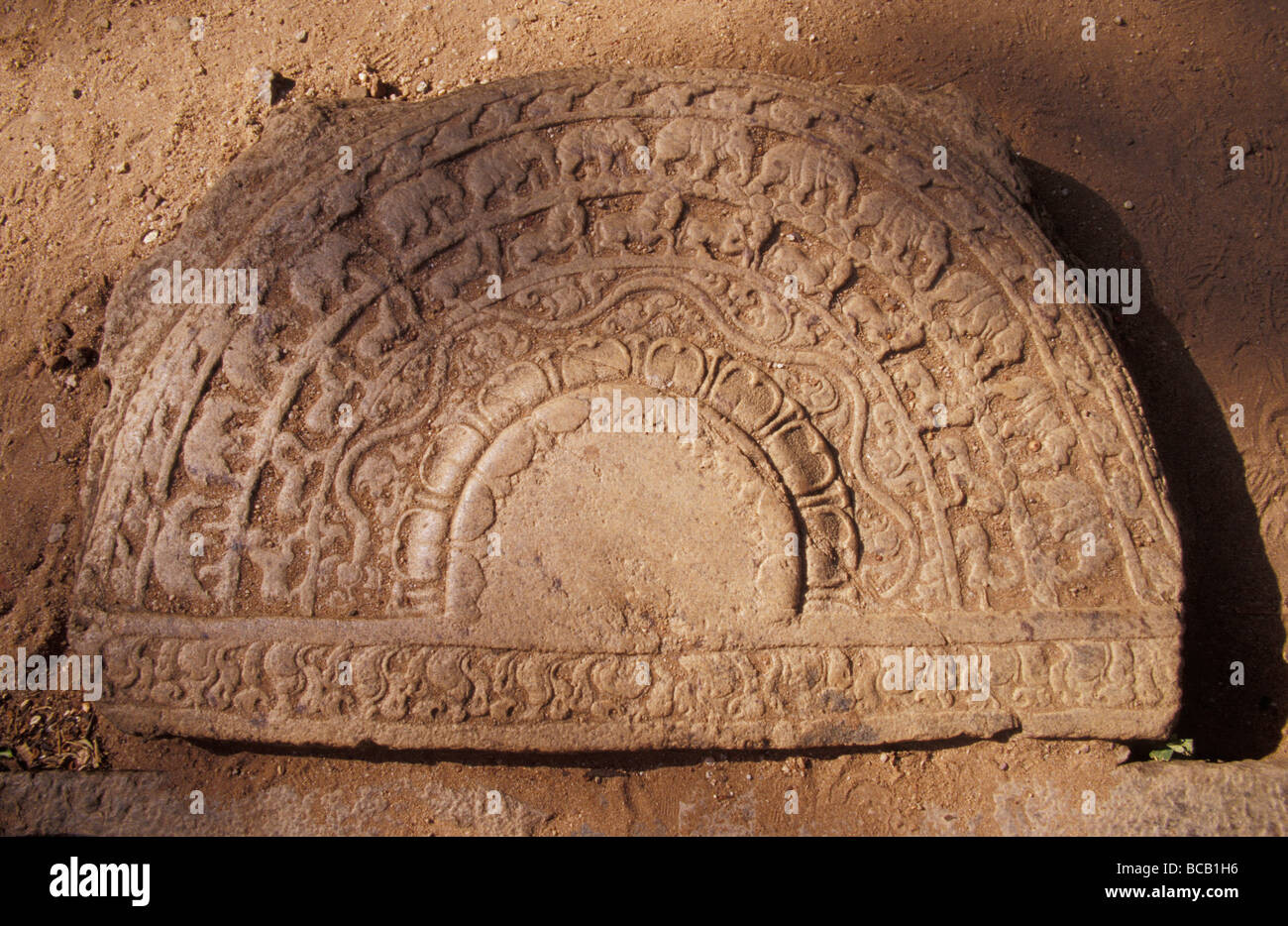 An ornately carved ancient Moon Stone depicting Elephants and Horses. Stock Photo