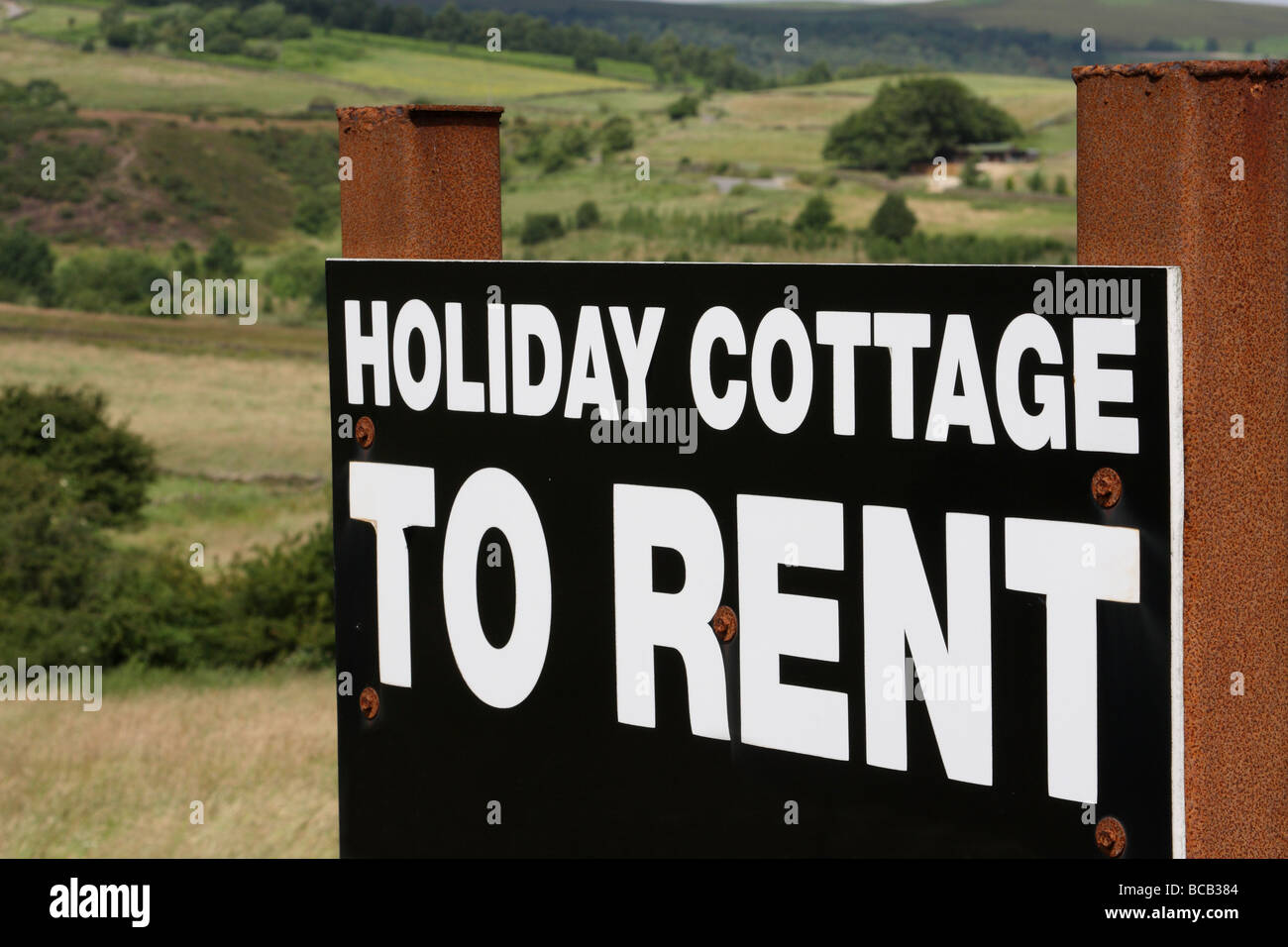 Holiday cottage to rent sign in the English countryside. Stock Photo
