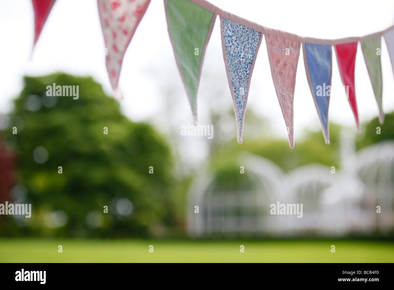 Bunting hung in the garden for a picnic. Stock Photo