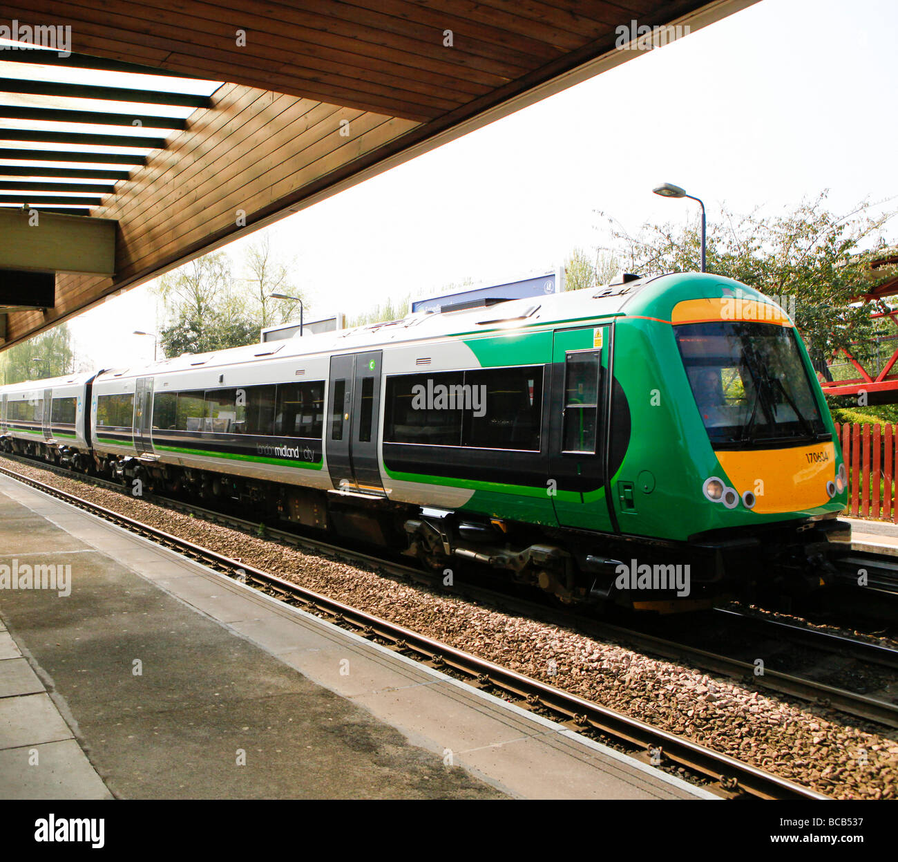 Trains at arriving at a train station. Stock Photo