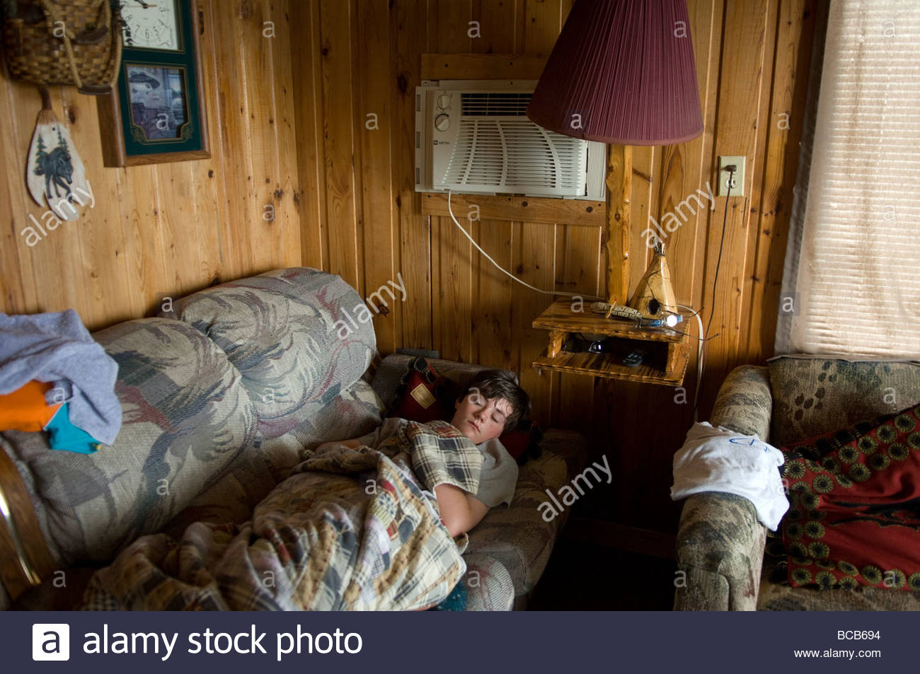 A Teenage Boy Sleeps In A Cabin In Leech Lake Minnesota Stock