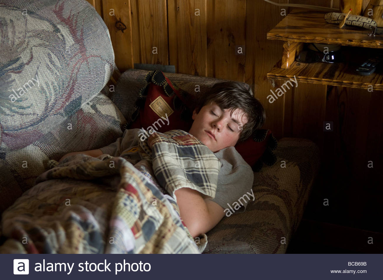 A Teenage Boy Sleeps In A Cabin In Leech Lake Minnesota Stock